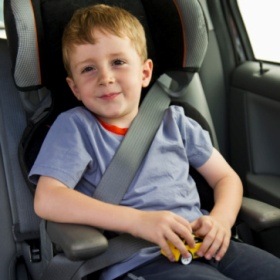 Young boy sitting in his car seat